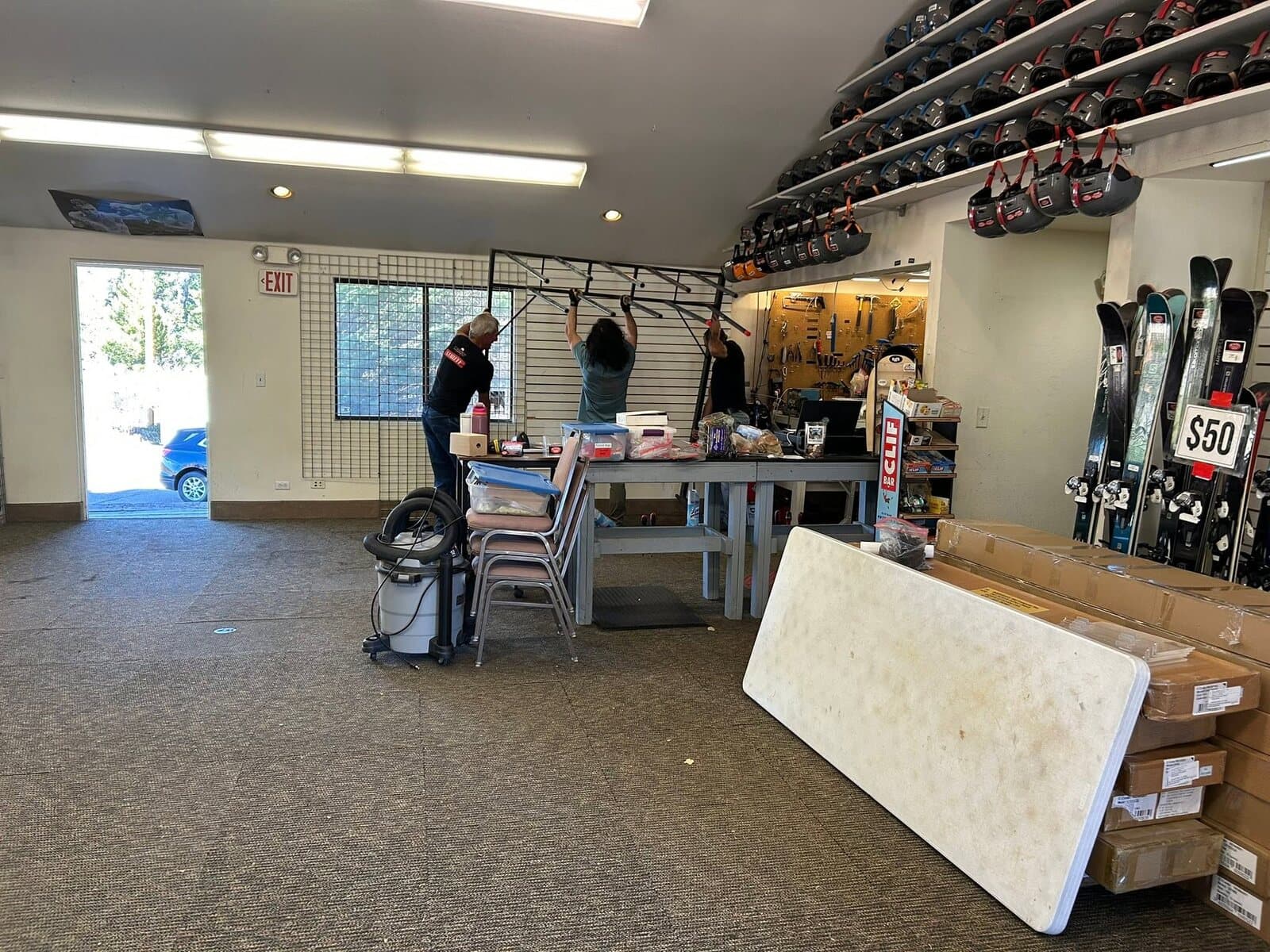 Inside the ski rental shop — counter, racks, and rental gear